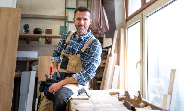 istock Portrait of mature carpenter posing in his carpentry workshop with tools in background 1214267978