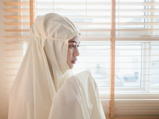 istock Islamic woman praying near window 1214268026