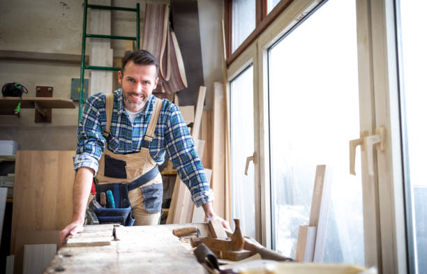 istock Portrait of mature carpenter posing in his carpentry workshop with tools in background 1214268085