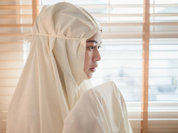 istock Young Muslim woman praying at home 1214268122
