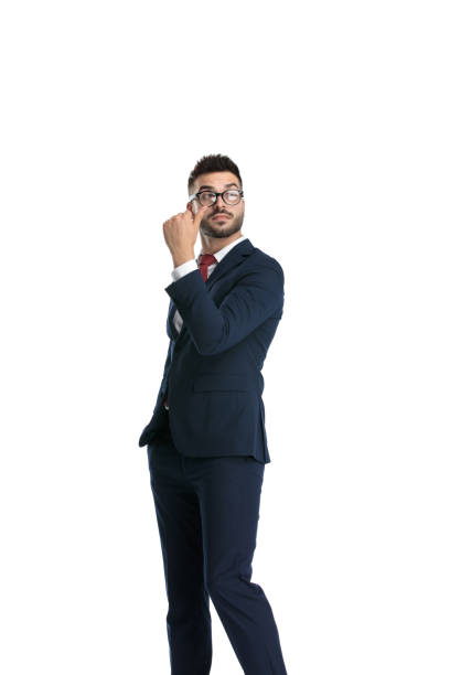 istock businessman standing and pointing finger behind him serious 1214268713