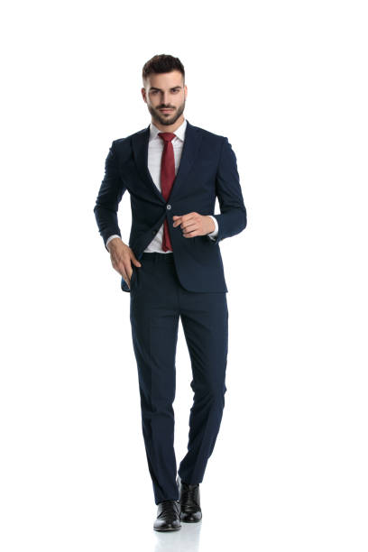 istock businessman walking while pulling hand out of pocket happy 1214270083