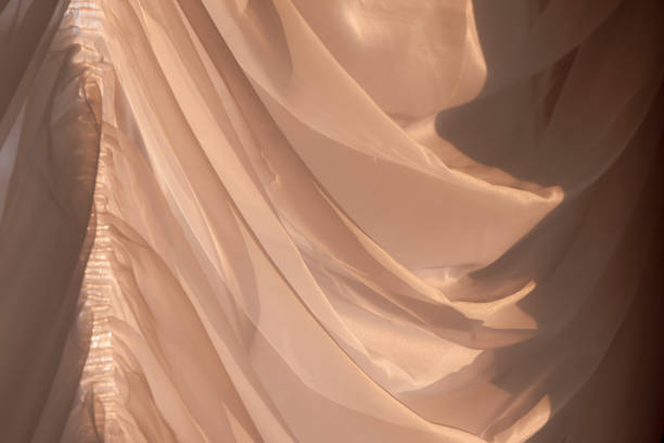 istock Elegant, thin transparent curtain on the window, by sunlight. Selective soft focus. 1214270548