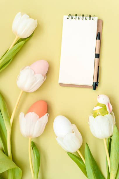 istock Delicate white tulip flowers on green background. Easter day, springtime concept. Flat lay, top view, copy space 1214270583