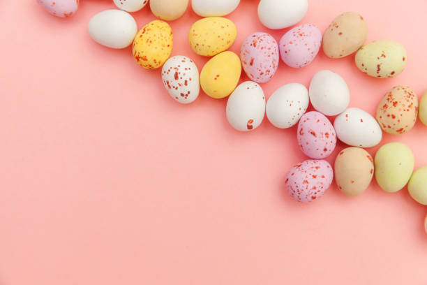 istock Happy Easter concept. Preparation for holiday. Easter candy chocolate eggs and jellybean sweets isolated on trendy pastel pink background. Simple minimalism flat lay top view copy space 1214270921