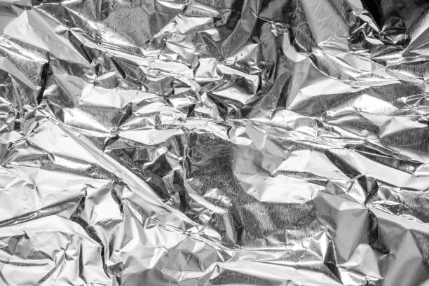 istock aluminium foil crumpled Silver texture abstract background 1214272256