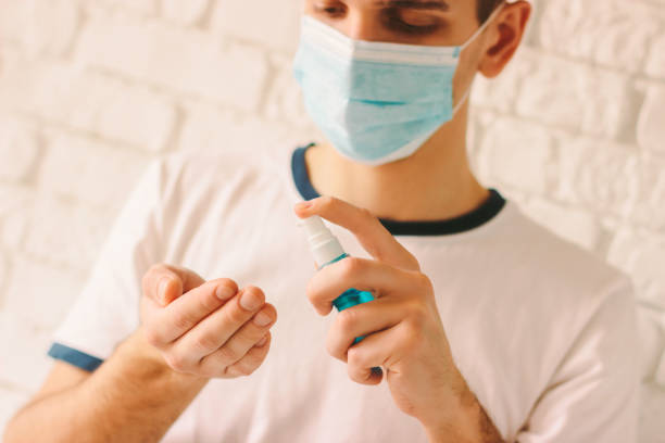 istock Confident man applying sanitizer on his palm 1214273612