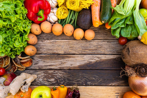 istock Colorful composition of assorted vegetables: tomato, egg,garlic,lemon,salad,mango,onion,lettuce, cabbage, onions, bell peppers,Studio photography. No people. Healthy eating concept. Organic and fresh food concept.on  background 1214273974