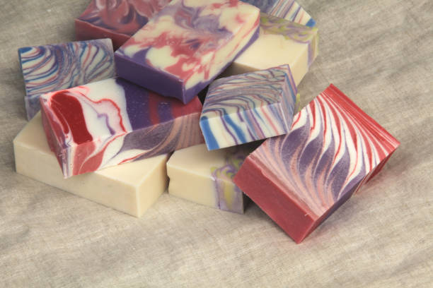 istock Pile of cold process design soaps on display on linen backdrop 1214276131