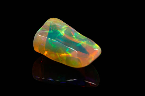 istock macro mineral stone rare and beautiful opals on a black background 1214276759