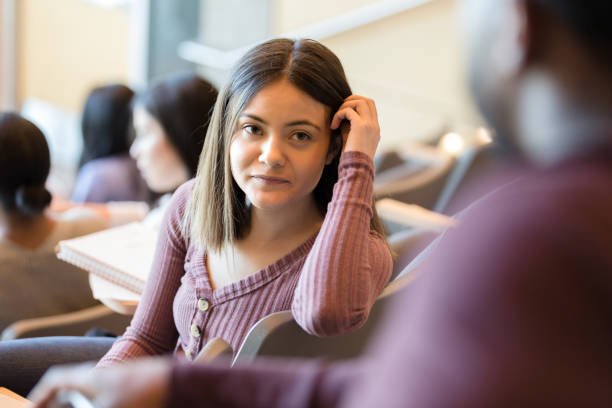 istock Female college student talks with friend before class 1214278909