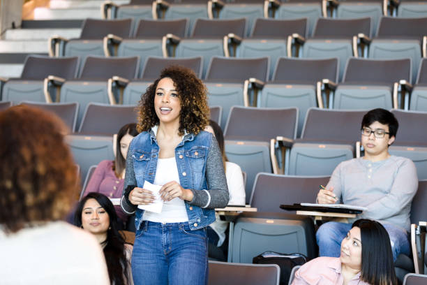 istock Confident college student gives presentation to college professor 1214278964