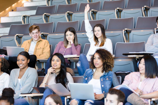 istock Female college student raises hand during class 1214279044