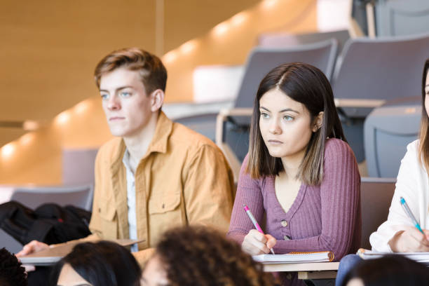 istock Serious male and female students attend college class 1214279066