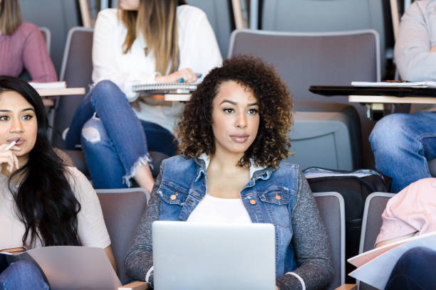istock Serious female college student taking notes on laptop 1214279105