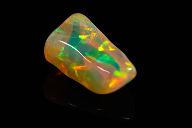 istock macro mineral stone rare and beautiful opals on a black background 1214279828