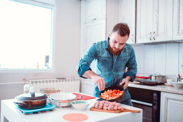 istock Male In Charge Of Cooking Dinner With Meat In Kitchen 1214282926