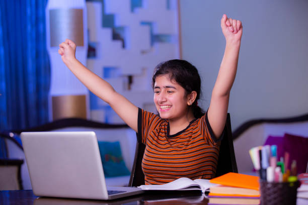Teenager girl doing her homework stock photo Teenager, Homework, Learning, Book, teenage high school girl raising hand during class stock pictures, royalty-free photos & images