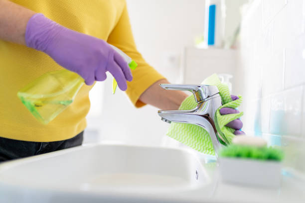 istock Hands holding disinfectant and rag to clean tap 1214286066