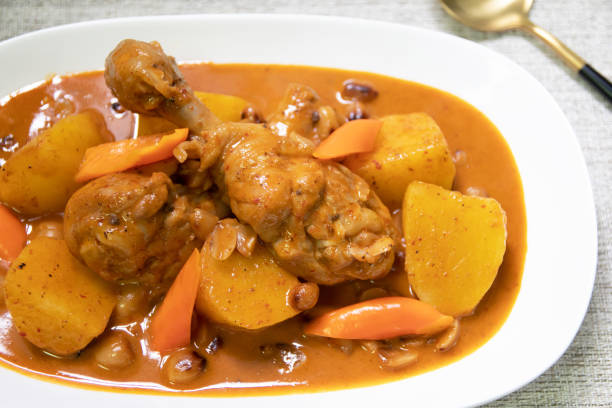 poulet mussaman curry est l’un des plats de curry thaïlandais les plus délicieux. curry de poulet crémeux avec noix et pommes de terre cuites molles servies sur peluche. - thai culture food ingredient set photos et images de collection