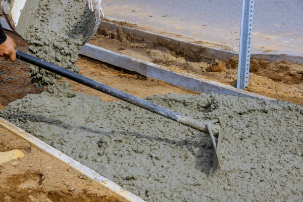 istock Construction process in the making of freshly pouring cement during sidewalk upgrade 1214289028