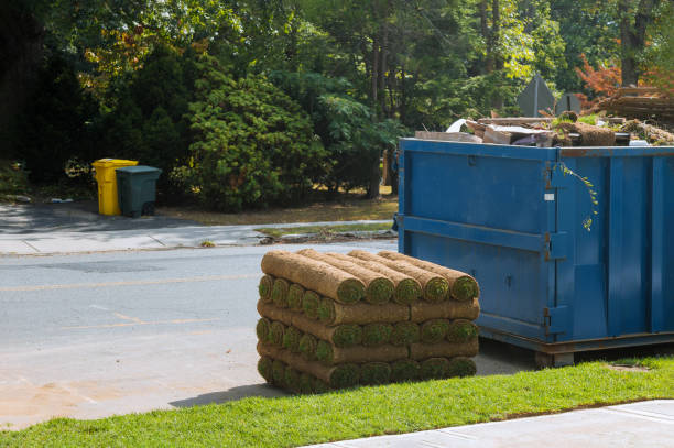 istock Stacks of sod rolls for new lawn and dumpster full garbage container residential construction home Installation of a modern landscape 1214289158