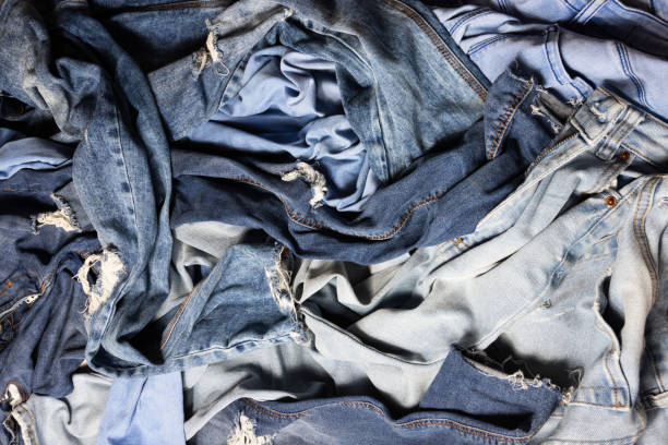 istock Different blue colored female jeans mixed, messy pile of navy jeans 1214289517