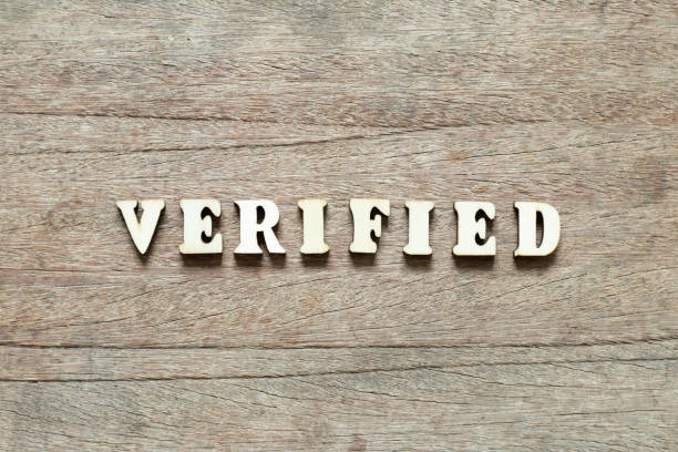 istock Letter block in word verified on wood background 1214293012