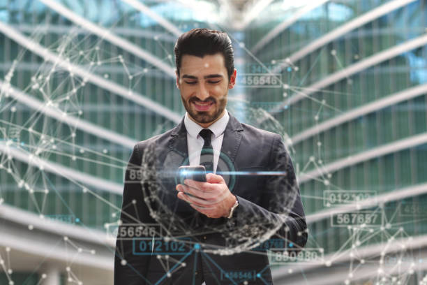 istock A businessman in a suit uses holography and augmented reality to see in 3D graphics connecting people. 1214293174