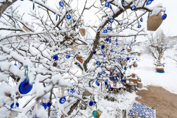 istock Blue Evil eye charms with snowy landscape in Cappadocia 1214293477