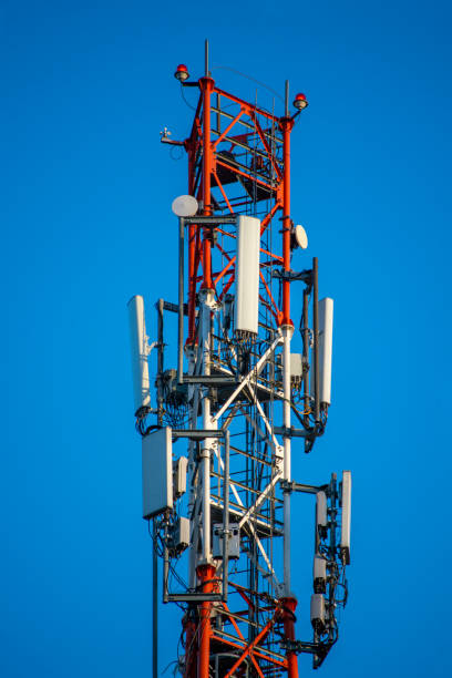 istock Telecommunication tower of 4G and 5G cellular. Cell Site Base Station. Wireless Communication Antenna Transmitter. Telecommunication tower with antennas against blue sky. 1214293631