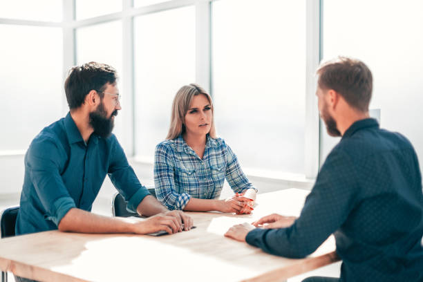 istock managers and job seeker sitting at the table during the interview 1214293721