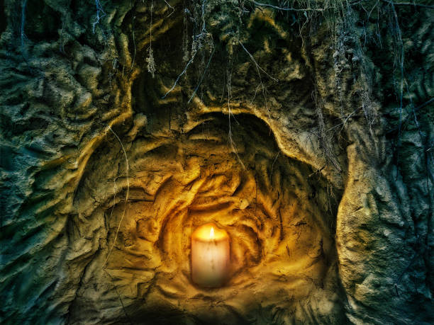 istock The candle burns standing on the stones 1214294926
