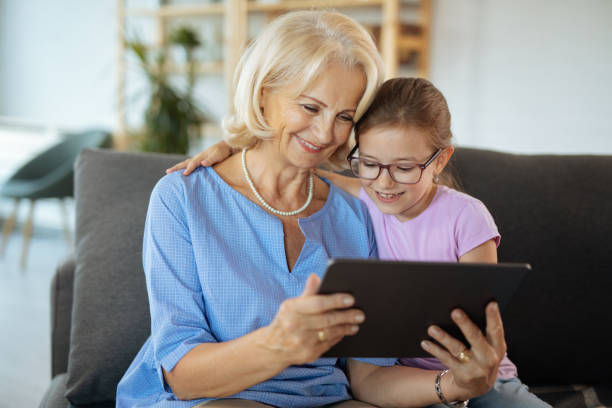 istock Grandma and granddaughter with digital tablet 1214295255