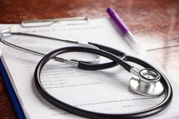istock The stethoscope put on blurred Insurance claim form,blurry light around 1214295295