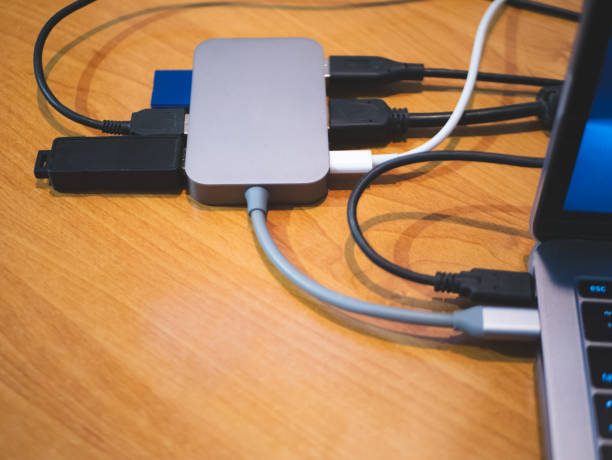 usb type-c hub connected to laptop with lot of cables connected for peripheral computer device equipment usb type-c hub connected to laptop with lot of cables connected for peripheral computer device equipment. byte photos stock pictures, royalty-free photos & images
