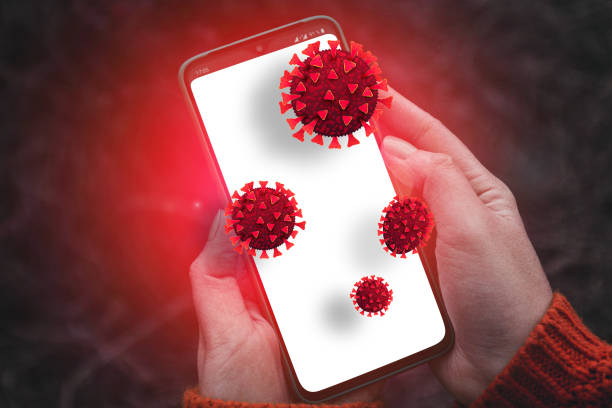 istock Person hands holding smartphone with dirty infectious bacteria and harmful germs on mobile smartphone display. Online hacker attack on confidential information or personal data 1214296241
