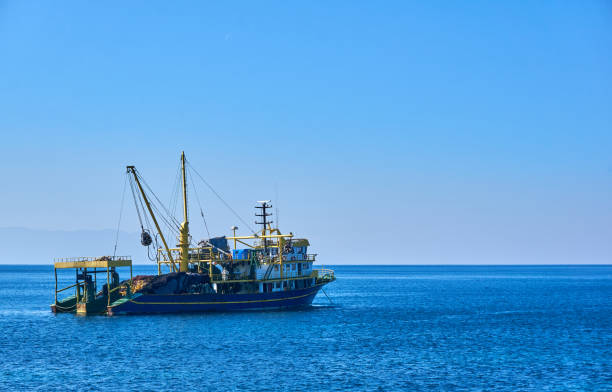 trawl fishing boat near plan shot - rede de arrastão imagens e fotografias de stock