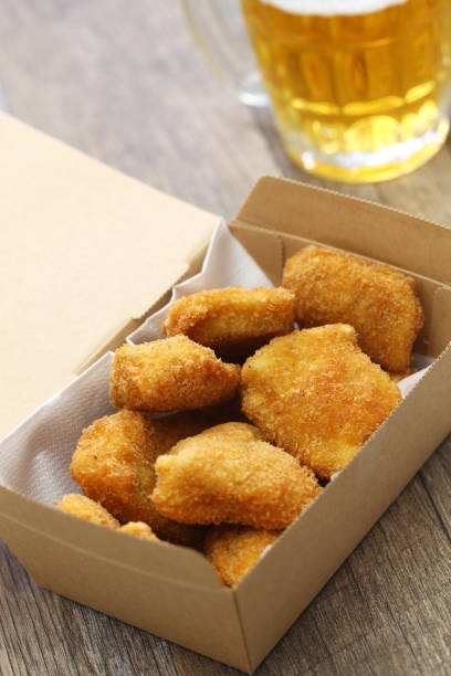 istock homemade chicken nuggets and beer 1214299381