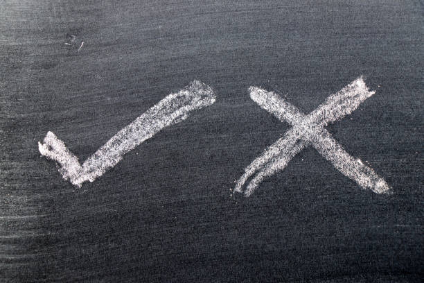istock White color chalk hand drawing in check mark of right and wrong shape on black board background 1214299671