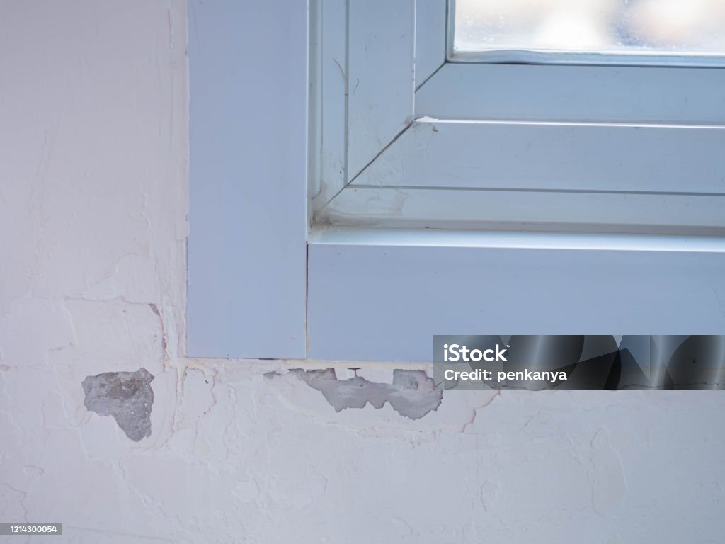 Paint blistering and peeling problems on the wall with aluminum window flame. Paint Stock Photo