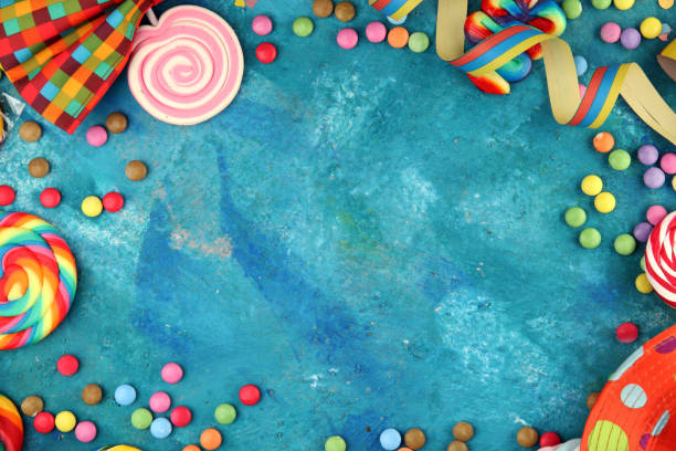 istock Colorful carnival border over a cool textured background with copy space with party hats, candy, streamers and hearts. Party Carnival decoration 1214300146
