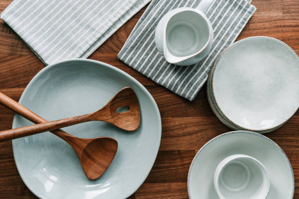 istock Set of kitchen ceramic tableware on a wooden table. Eco style home still life, top view. 1214302048