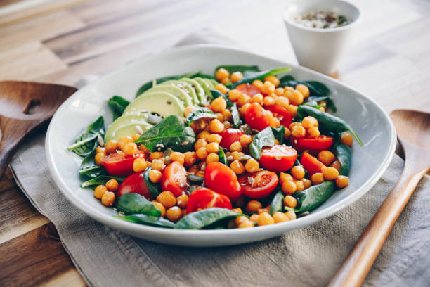 istock Fresh healthy salad with chickpea, avocado, cherry tomatoes and spinach. 1214302107