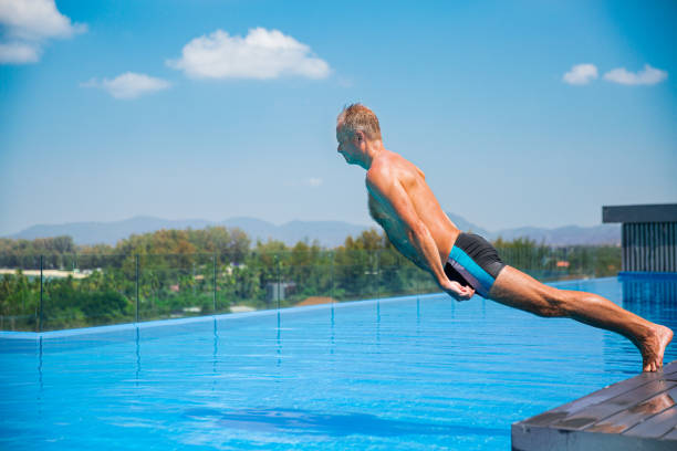 Unemotional funny man falling into swimming pool. Summer vacation