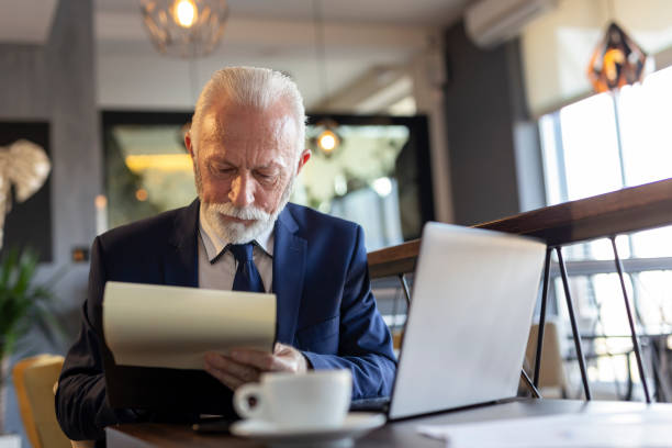 istock Senior businessman signing contracts 1214304355