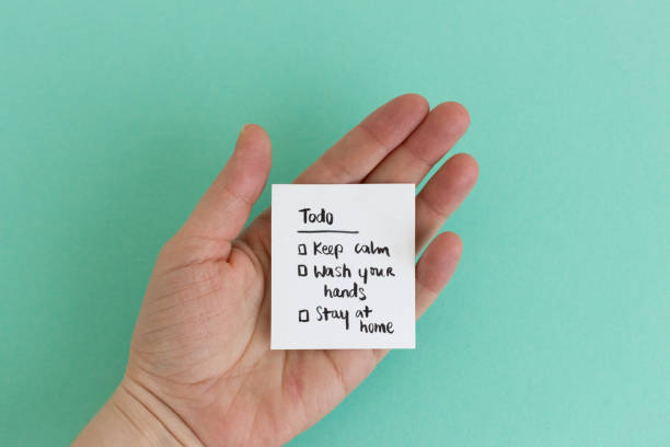 Female hand with yellow sticky note – Isolated with clipping path