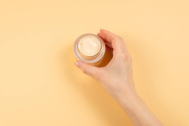 istock Hand cream and woman hands on a beige background. 1214304811