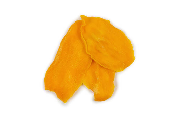 istock Tasty sugar mango slices background. Top view. 1214305440