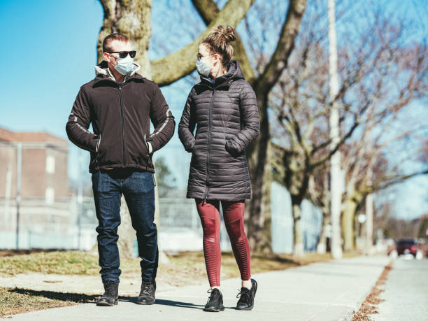 istock COVID-19, Young couple meeting outside 1214307391